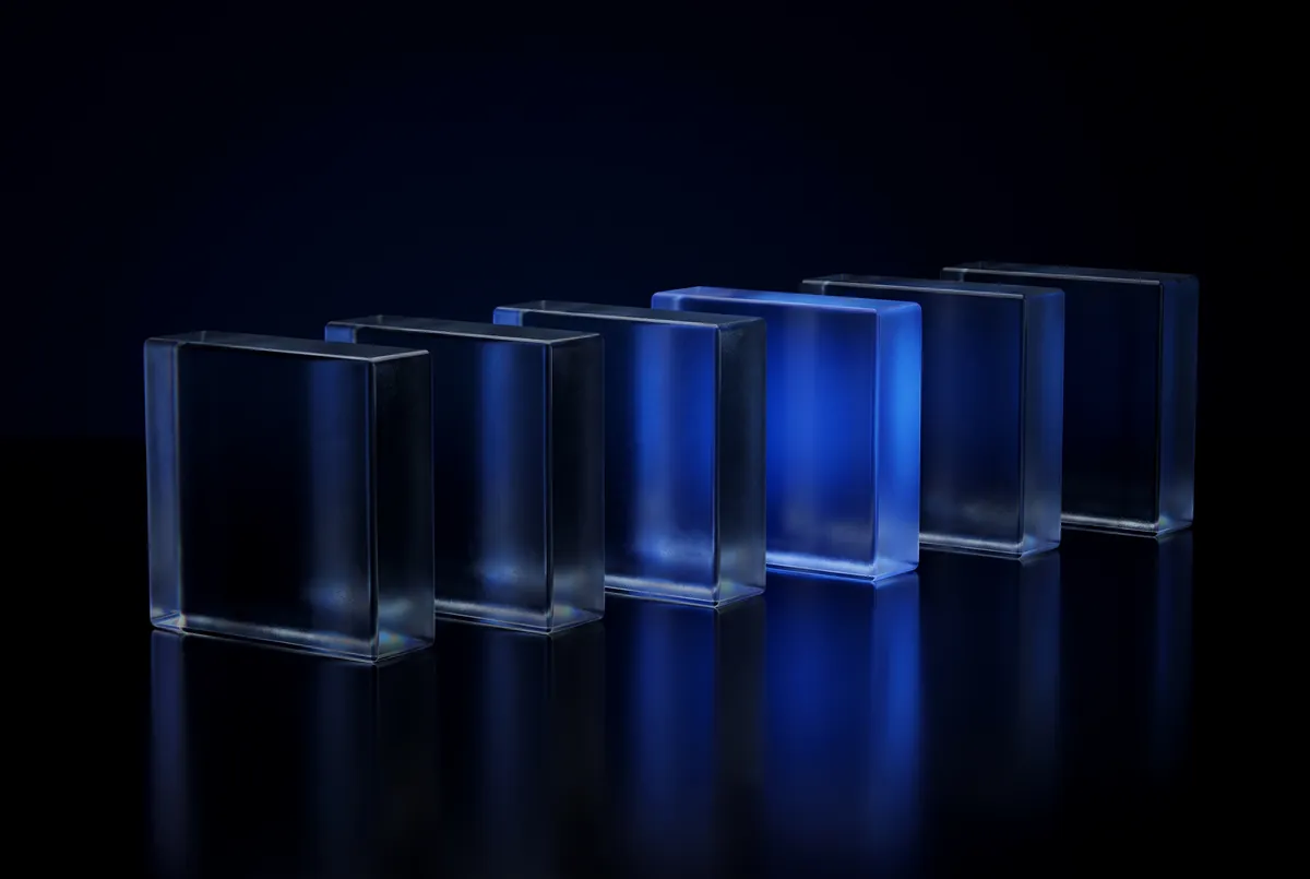 A row of blank glass blocks with one glowing blue