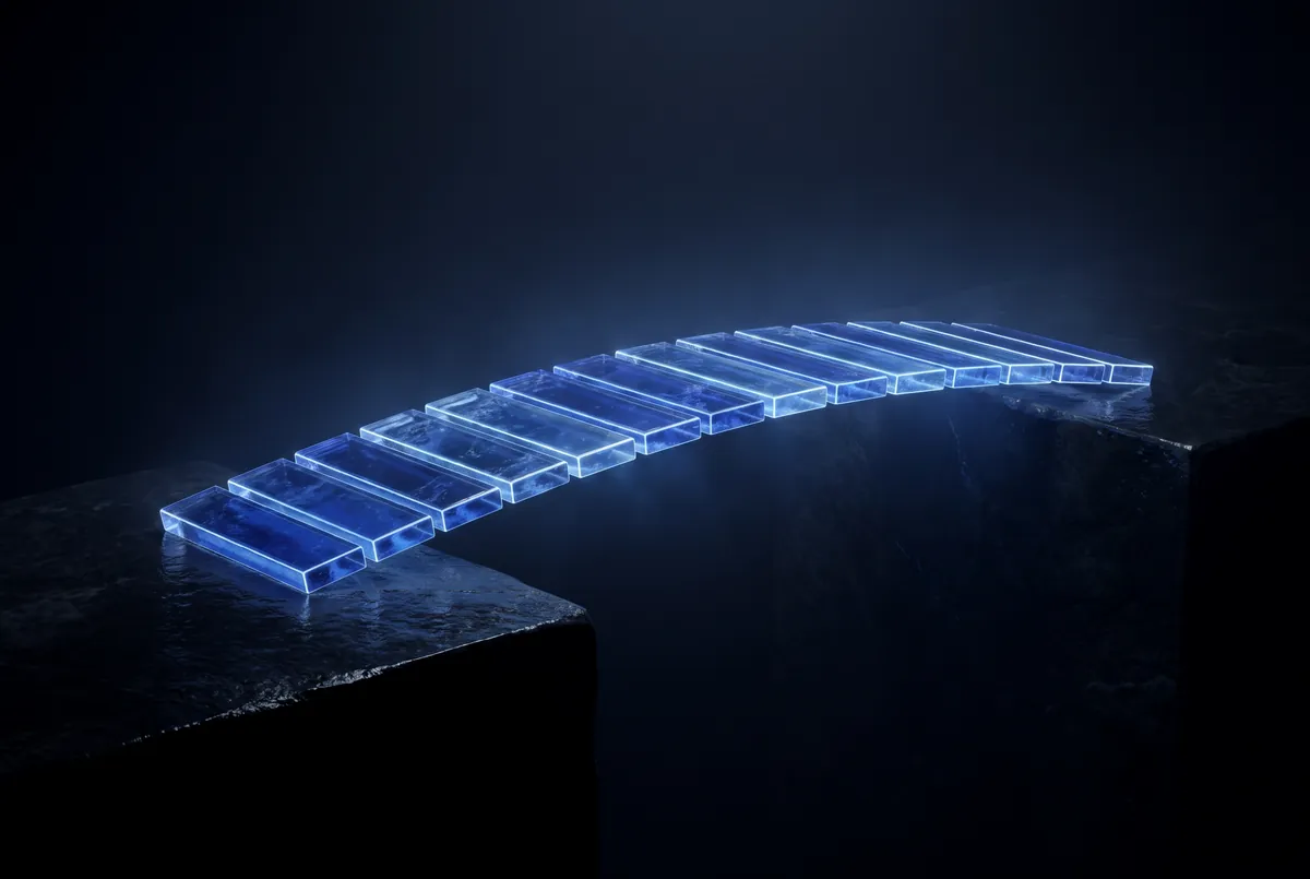 A bridge of glowing glass tiles between two stone platforms